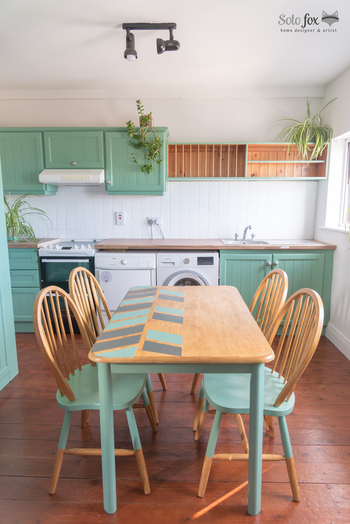 Renovated kitchen and dining table with sage green accents