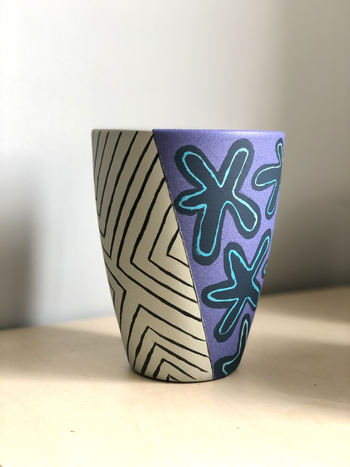 Flat top cone plant pot painted with stripes and blobs